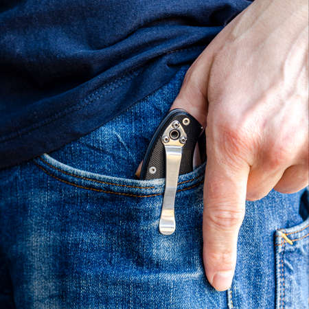 Man hands in gloves holding the knifeの写真素材