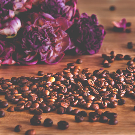Background of roasted coffee beans. Coffee scattered on a wooden tableの写真素材