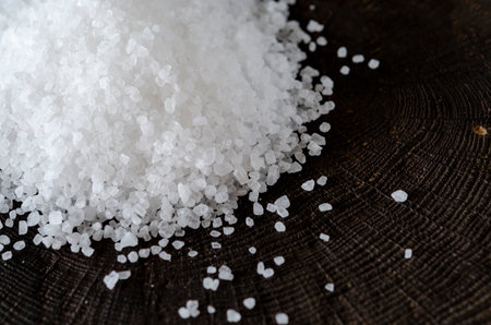 White crystals of salt scattered on a wooden backgroundの写真素材
