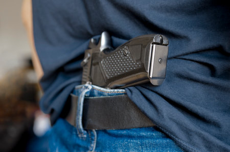 Black Handgun Behind Black Belt. Black gunの写真素材