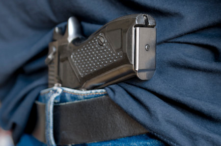 Black Handgun Behind Black Belt. Black gunの写真素材