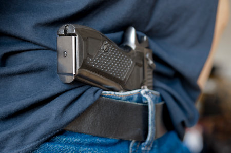Black Handgun Behind Black Belt. Black gunの写真素材