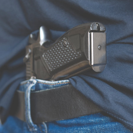 Black Handgun Behind Black Belt. Black gunの写真素材