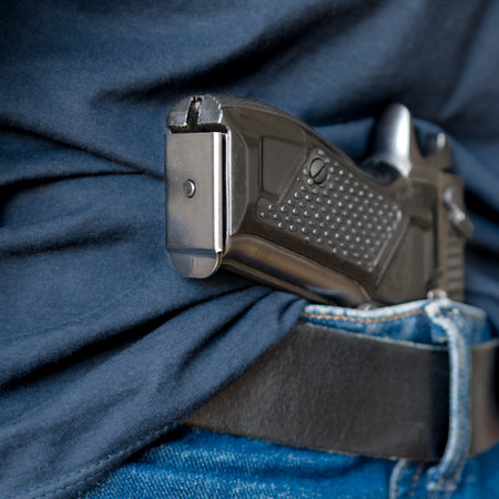 Black Handgun Behind Black Belt. Black gunの写真素材