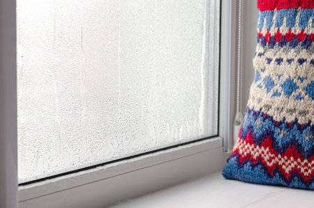 Drops of condensate and black mold on a substandard metal-plastic window. plastic. Ecologyの写真素材
