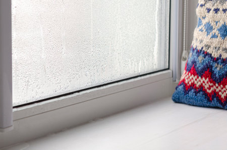 Condensate droplets on the glass of the metal-plastic window and on the window sillの写真素材