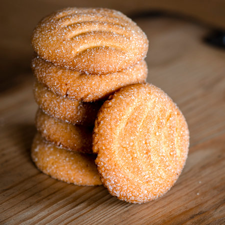 Homemade rosy cookies lie on a wooden trayの写真素材