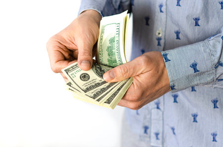 Counting dollars by the hands of a man. Currency exchangeの写真素材