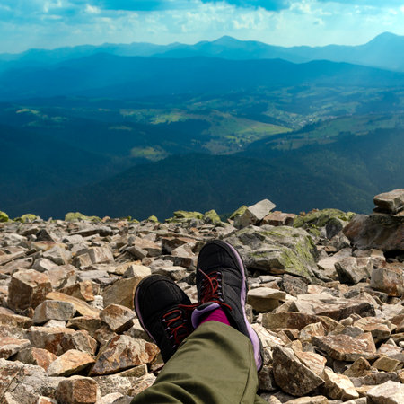 Hiking in the mountains. A tourists feet on top of a mountainの写真素材