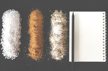 Set of spices and salt for cooking on black background with space for textの写真素材