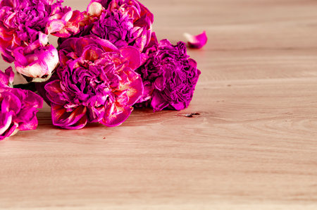 A bouquet of lilac peonies lies on a wooden background. Flowersの写真素材