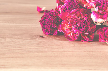 A bouquet of lilac peonies lies on a wooden background. Flowersの写真素材