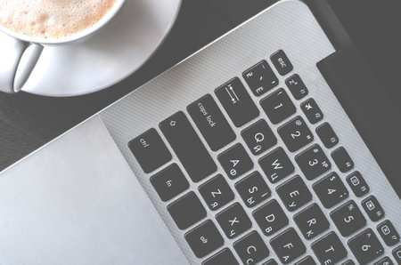 A laptop and a cup of coffee. Freelance workplace.