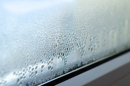 Greenhouse effect. Drops of condensation on the glass of a metal-plastic window.の写真素材
