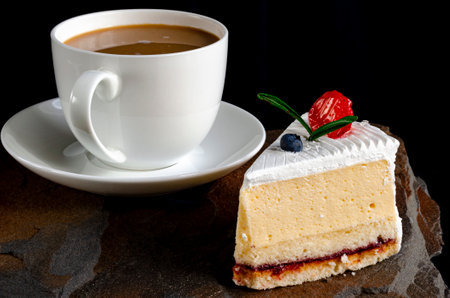 A slice of cherry cake and a cup of coffee. Dessertの写真素材