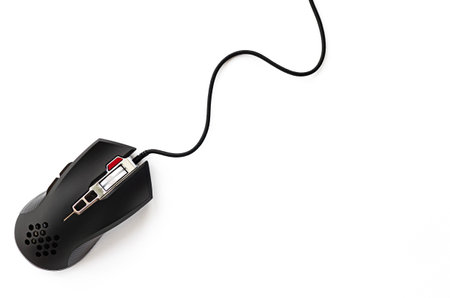 Black computer mouse close-up on a white background. Professional gaming wired mouse isolated on a white backgroundの写真素材
