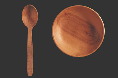 Eco-friendly cutlery made of wood. Spoon and plate on a black backgroundの写真素材