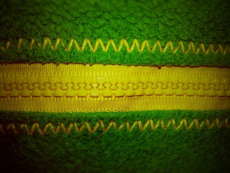 Background of bright green cloth with yellow claspの写真素材