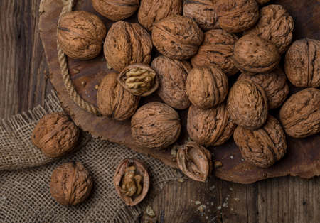 Walnuts on a dark wooden table, top viewの写真素材