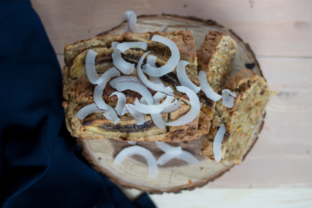 Homemade coconut carrot cake with lemon syrup. Dessert for gourmets. wooden background. Top view.の写真素材