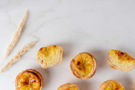Pastel de Nata - portugese egg custard pies on white background, copy space.