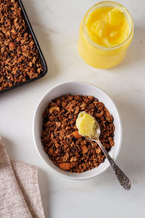 Homemade chocolate granola with ghee on a light background. Healthy food concept.の写真素材