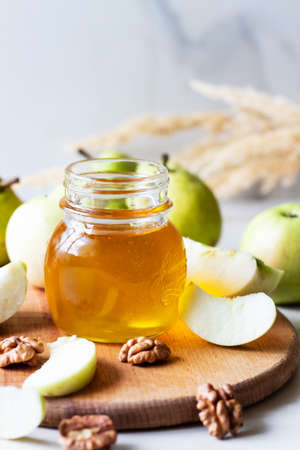 Honey jar with gardening green pears on wood board. Autumn harvestの写真素材