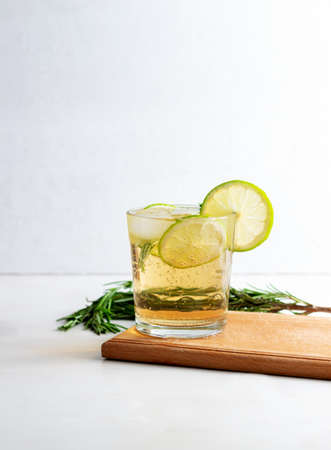 Cold fresh summer lemonade with lime and rosemary in glassの写真素材
