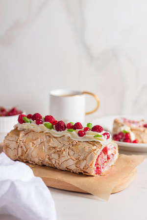 Meringue roll cake with berries whipped cream and Coffe. Summer dessert.の写真素材