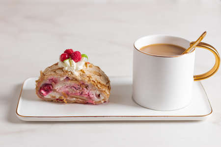 Meringue roll cake with berries whipped cream and coffe on marble background. Copy space.の写真素材