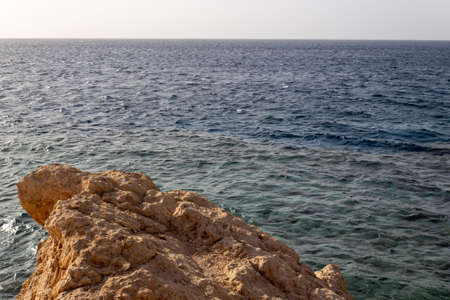 Landscape of big rocks with sunset light on sea background.の写真素材
