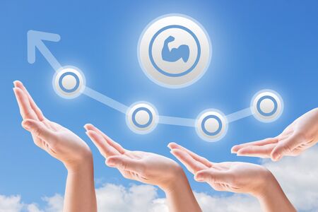 hands support the growth and promotion on the background of sky and clouds exerciseの写真素材