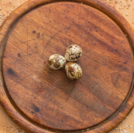 Quail eggs on wooden backgroundの写真素材