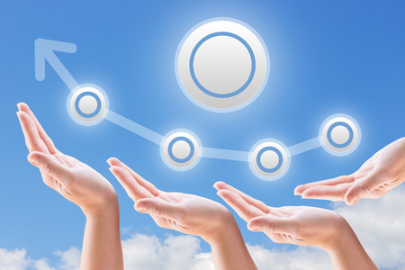 hands support the growth and promotion on the background of sky and cloudsの写真素材