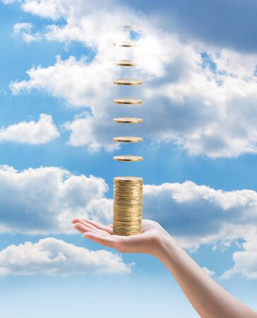 In hand, the sky rained coins. Symbolizes the profit, income, income without investment.の写真素材
