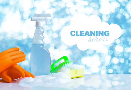 Cleaning service lettering and cleaning products on blurred background.の写真素材