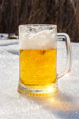 Glass of beer in the snow design banner.の写真素材