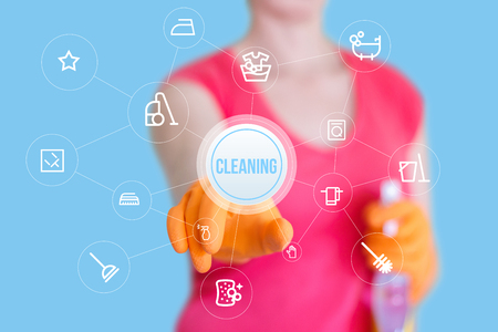 Worker clicks on the cleaning button on the blue background.の写真素材