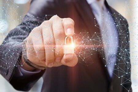 Security Lock in the hand of businessman concept.の写真素材