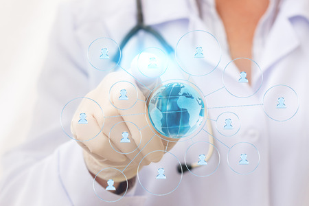 The doctor working in network with the patients on the virtual screen.の写真素材