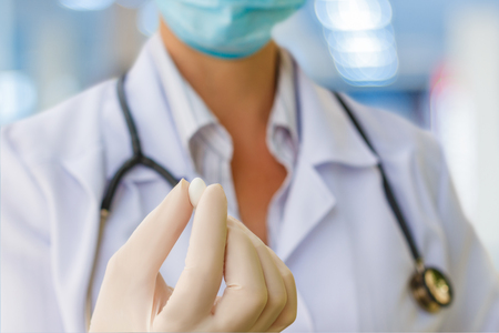 Medical worker with the pill in hand.の写真素材