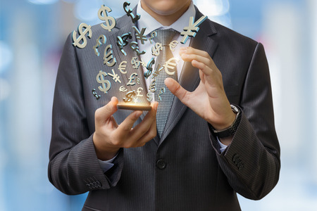 Currency symbols from the phone to the blurred background.の写真素材