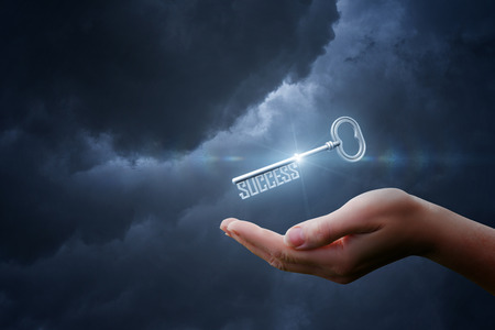 In hand a key with the words success .Concept design.の写真素材