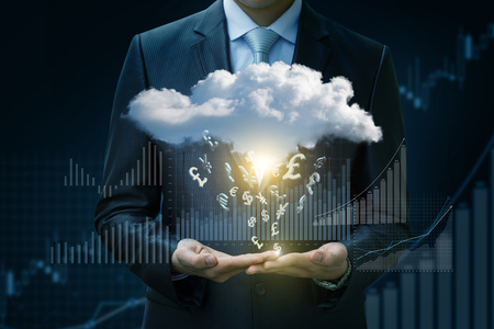 Currency symbols fall from the cloud on a blue background.の写真素材