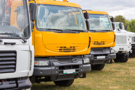 Group of trucks parked on the grass outdoors.の写真素材