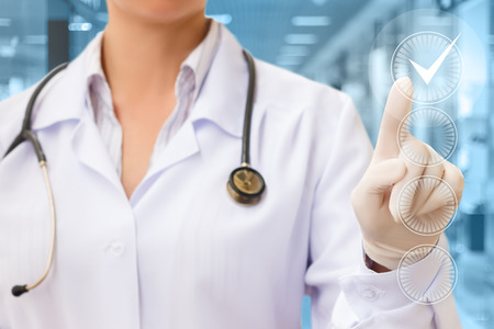 Doctor Hand Checking the Checking Box on blurred background.の写真素材