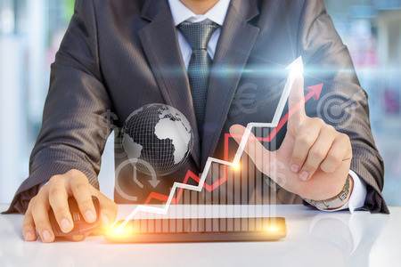 Businessman showing profit growth on virtual screen.の写真素材