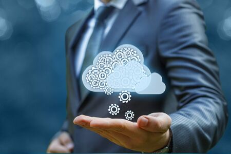 Businessman gets the information from the cloud on a blue background.の写真素材