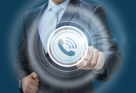 Businessman clicks on the button call. Call center.の写真素材