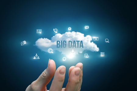 Hand showing a cloud with the words big data on blue background.の写真素材